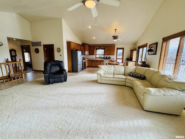 living room featuring ceiling fan, high vaulted ceiling, and light tile patterned floors