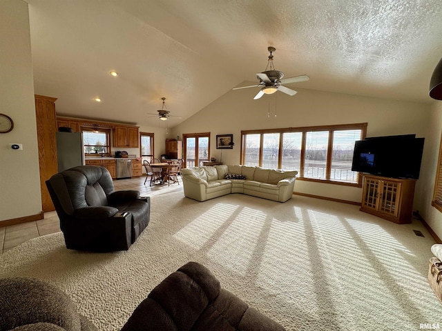 living room with high vaulted ceiling, sink, ceiling fan, light carpet, and a textured ceiling