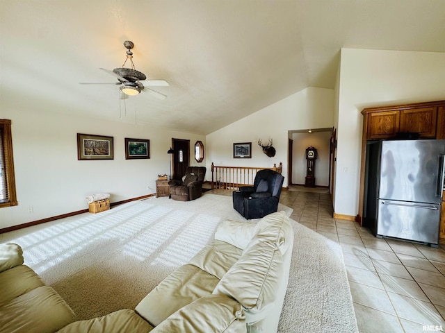 tiled living room with ceiling fan and lofted ceiling