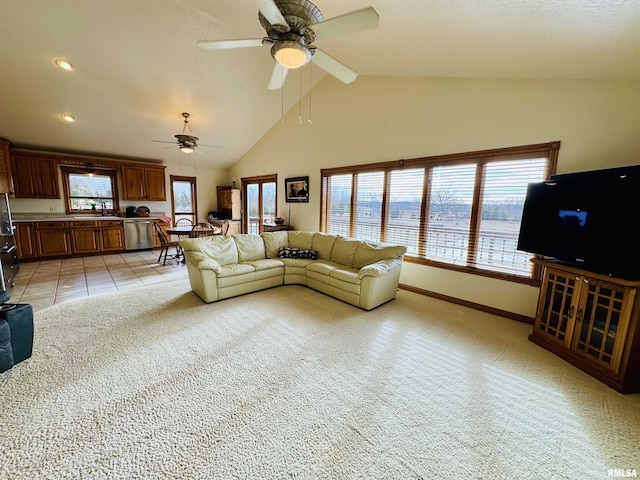 living room with ceiling fan, sink, light carpet, and high vaulted ceiling