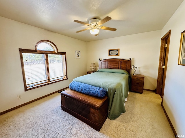 bedroom with light colored carpet and ceiling fan