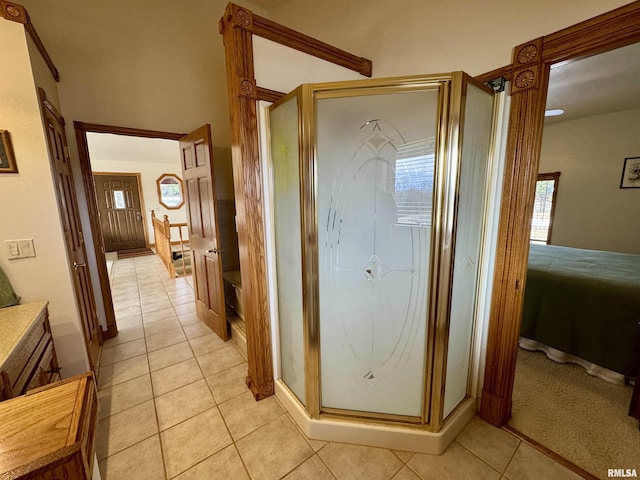 bathroom featuring vanity, a shower with shower door, and tile patterned floors