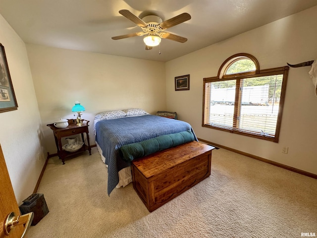 bedroom featuring light carpet and ceiling fan