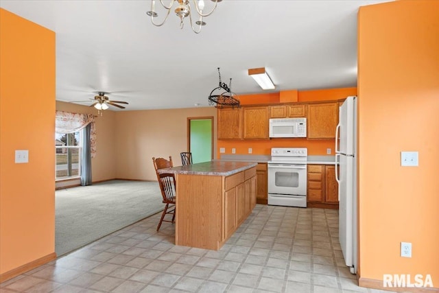 kitchen featuring white appliances, a breakfast bar area, ceiling fan, a kitchen island, and light colored carpet