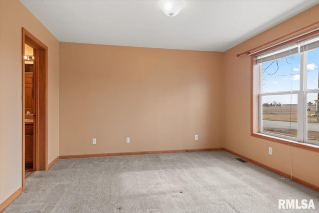 unfurnished room with light colored carpet