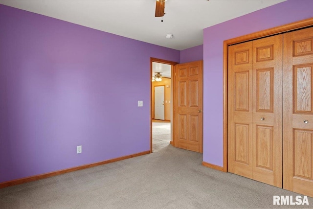 unfurnished bedroom featuring light colored carpet, a closet, and ceiling fan