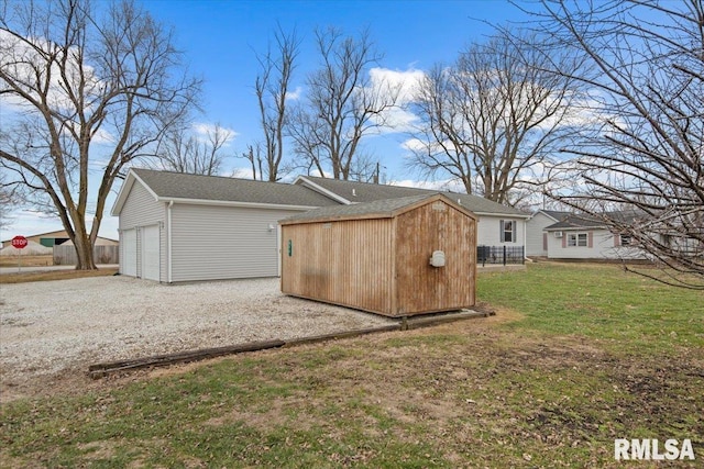 exterior space featuring an outbuilding, a garage, and a lawn