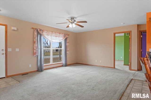 unfurnished living room featuring light colored carpet and ceiling fan