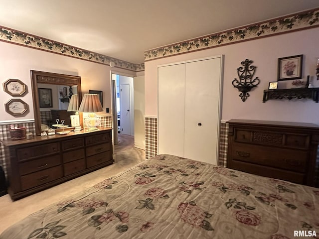 bedroom with light colored carpet and a closet