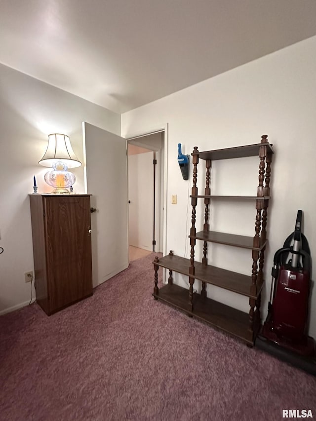 unfurnished bedroom with dark carpet