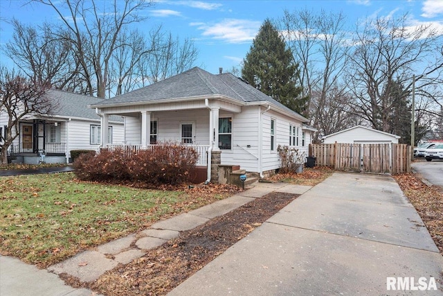 bungalow-style house with a front yard and covered porch