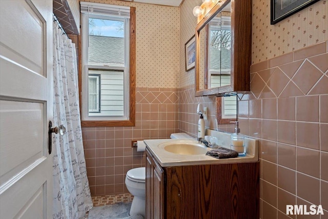 bathroom featuring vanity, tile walls, curtained shower, and toilet