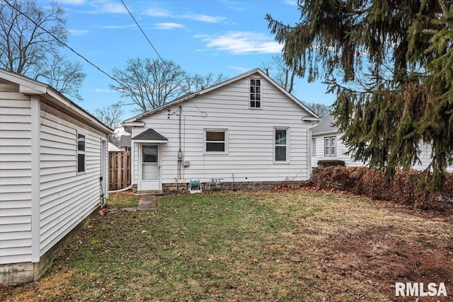 back of property featuring a lawn