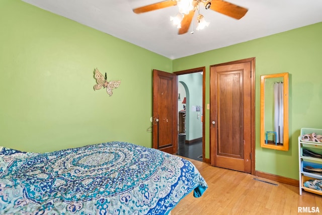 bedroom featuring hardwood / wood-style flooring and ceiling fan