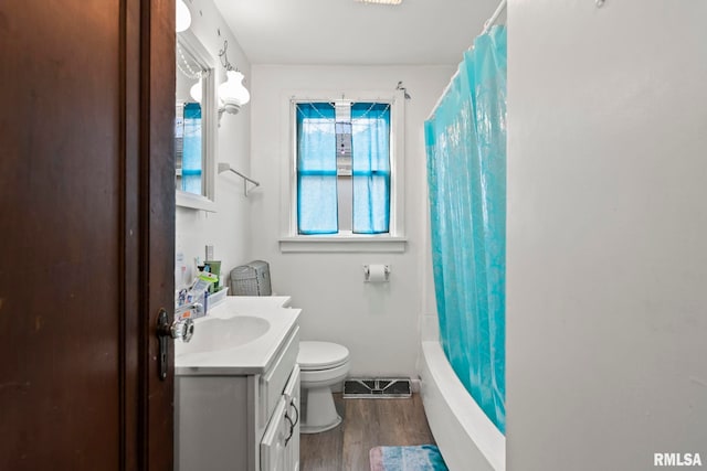 full bathroom with shower / bath combination with curtain, wood-type flooring, vanity, and toilet