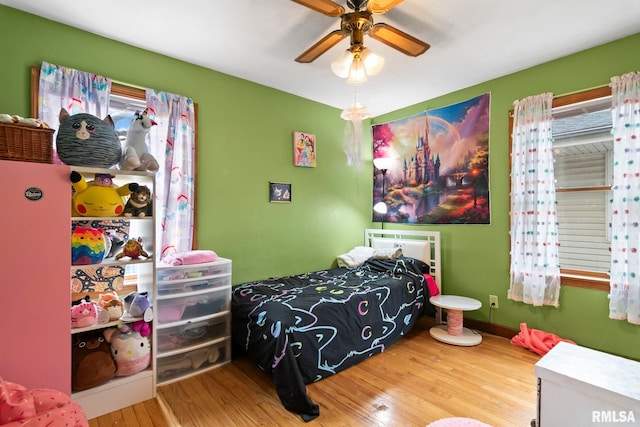 bedroom with ceiling fan and wood-type flooring