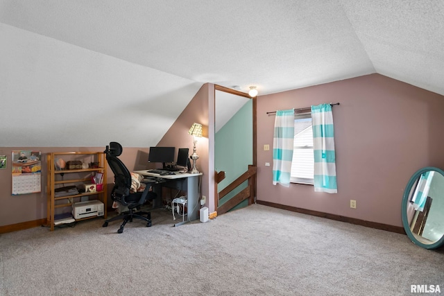 office area featuring vaulted ceiling, a textured ceiling, and carpet