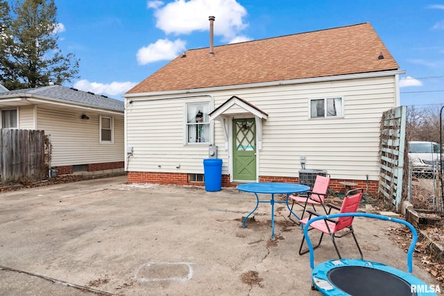 rear view of property with a trampoline and central air condition unit