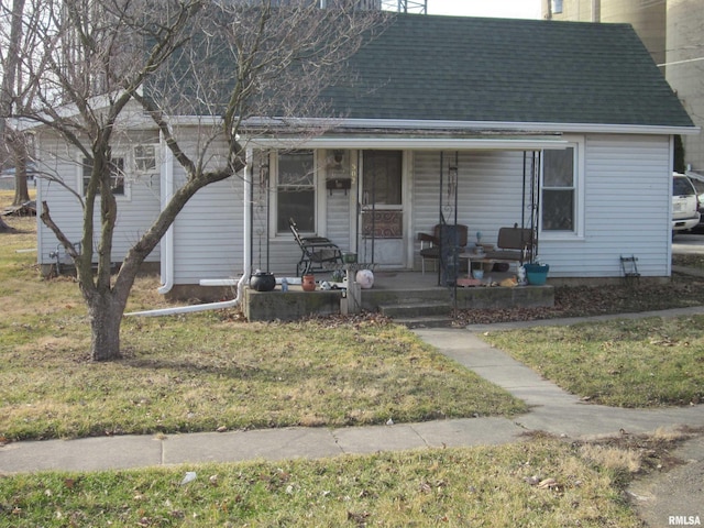 view of front of house with a front yard and covered porch