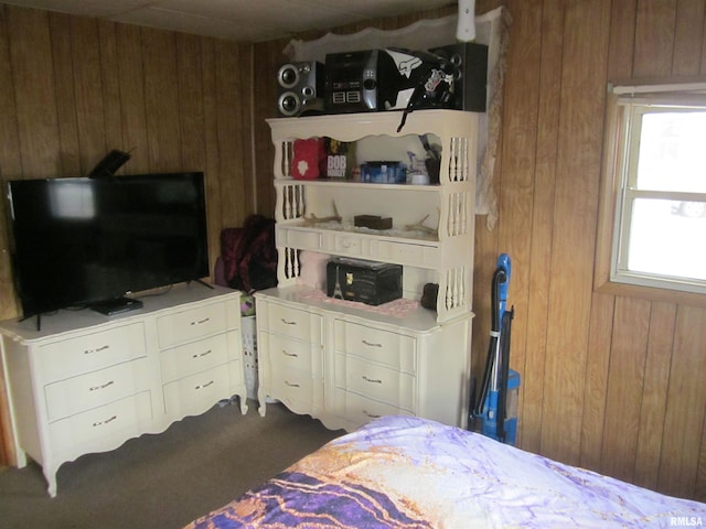 bedroom featuring wood walls