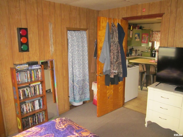 carpeted bedroom with wooden walls