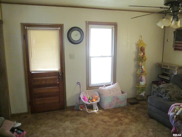 carpeted living room with ceiling fan