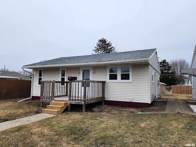 view of front of home featuring a front lawn and a deck