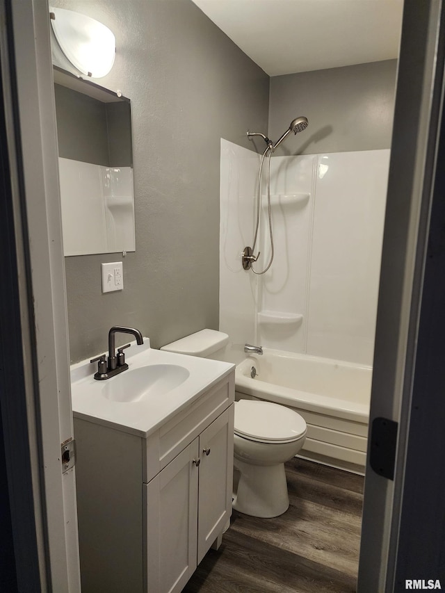 full bathroom with vanity, hardwood / wood-style floors, shower / tub combination, and toilet