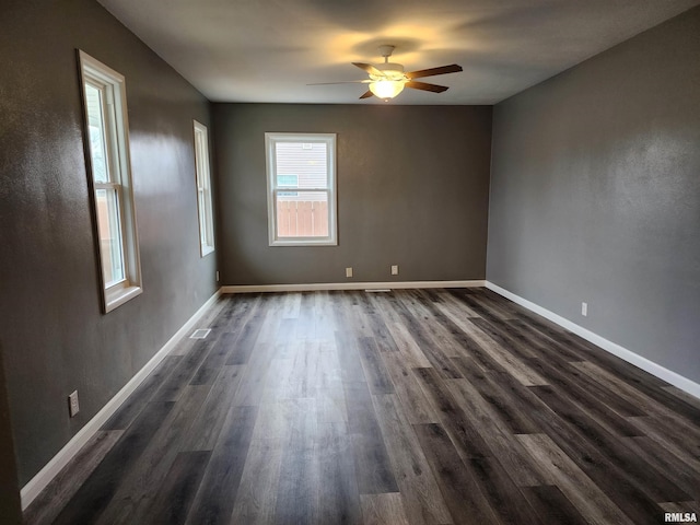 unfurnished room featuring dark hardwood / wood-style floors and ceiling fan