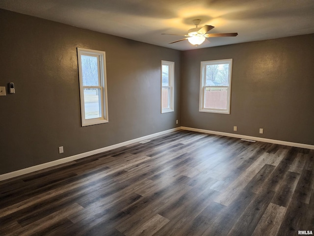 unfurnished room with ceiling fan and dark hardwood / wood-style flooring