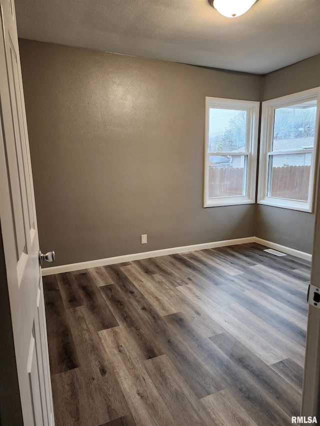 unfurnished room featuring dark hardwood / wood-style floors