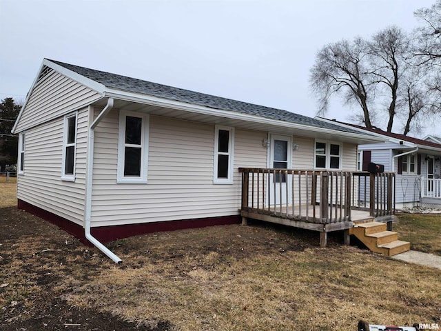 rear view of property featuring a deck