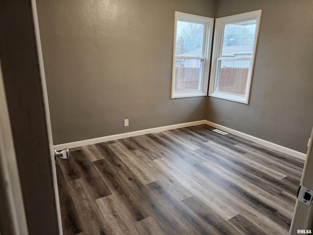 empty room with dark hardwood / wood-style floors