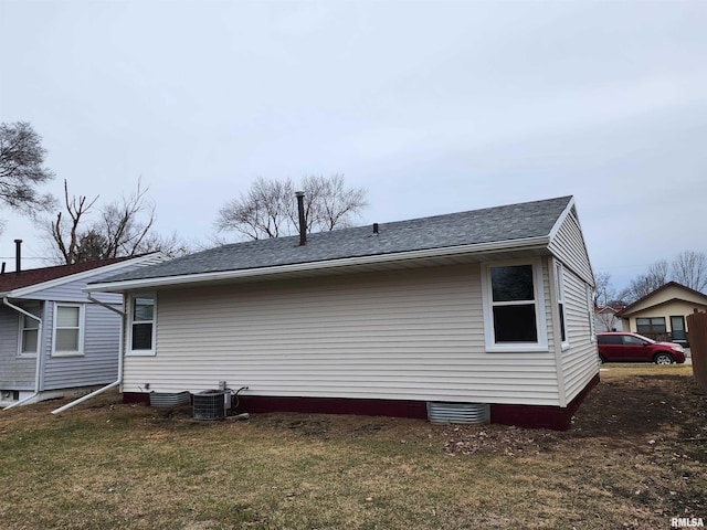 back of house with a yard and central air condition unit