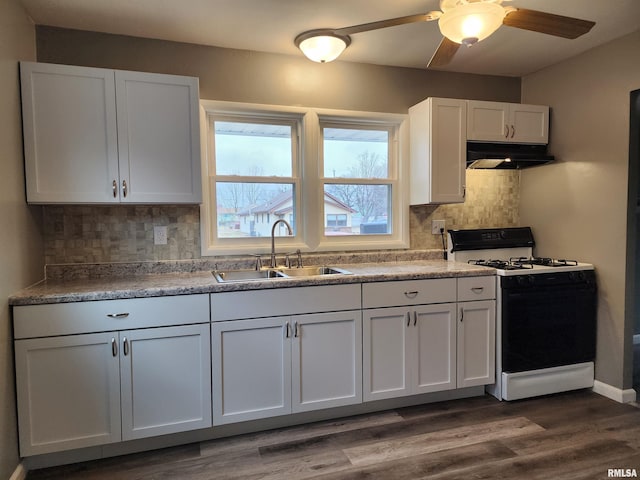 kitchen with dark wood-type flooring, sink, range with gas cooktop, tasteful backsplash, and white cabinets