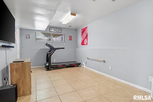 exercise room featuring light tile patterned flooring