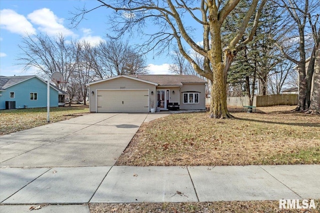 ranch-style house featuring a garage, central AC unit, and a front yard