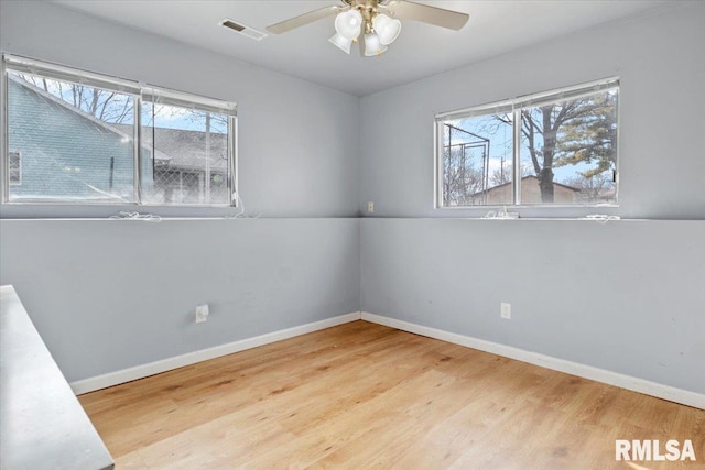 unfurnished room with light hardwood / wood-style flooring, ceiling fan, and plenty of natural light