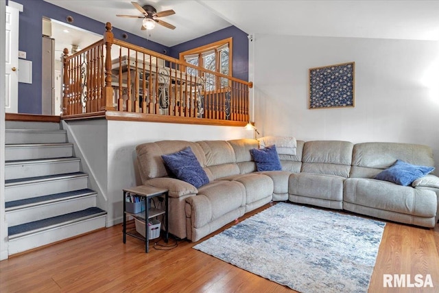 living room featuring wood-type flooring and ceiling fan