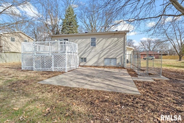 back of house featuring a patio area and a deck