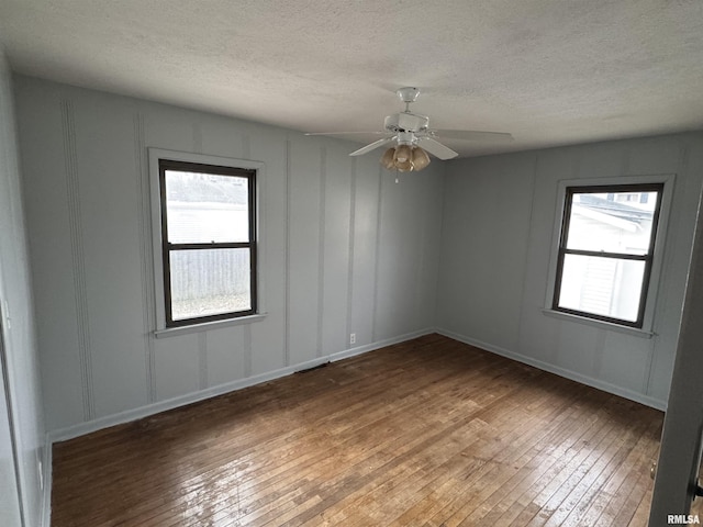 spare room featuring hardwood / wood-style floors, a textured ceiling, and ceiling fan