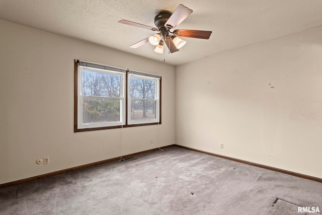 carpeted empty room with ceiling fan and a textured ceiling