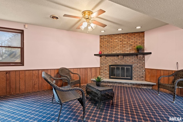 view of patio / terrace with ceiling fan and a fireplace