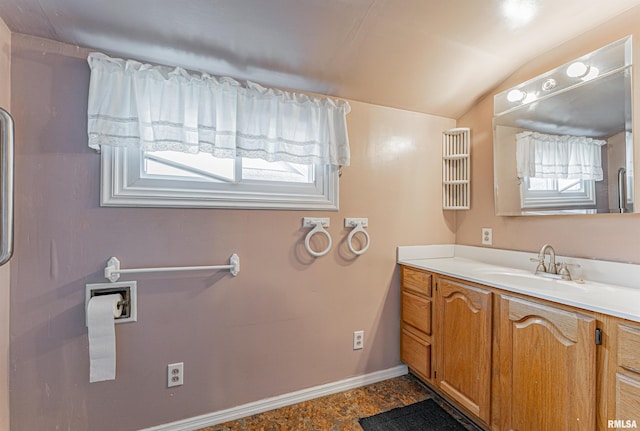 bathroom with vanity and lofted ceiling