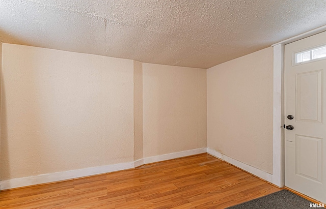 interior space with hardwood / wood-style floors and a textured ceiling