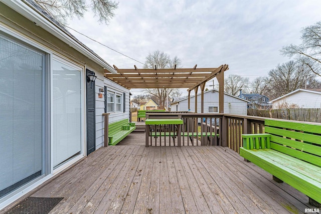 deck featuring a lawn and a pergola