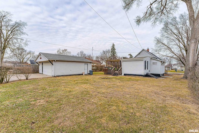 view of yard with a garage and an outdoor structure