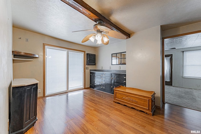 interior space with a textured ceiling and light hardwood / wood-style floors