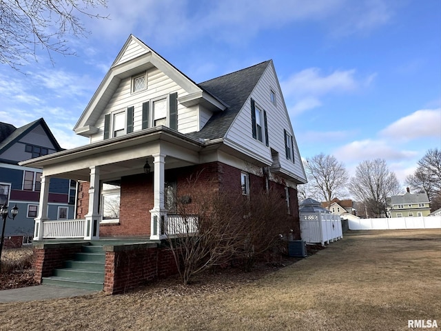 view of front of property featuring cooling unit and covered porch