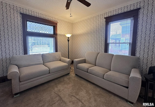 living room featuring a healthy amount of sunlight, a textured ceiling, and carpet flooring